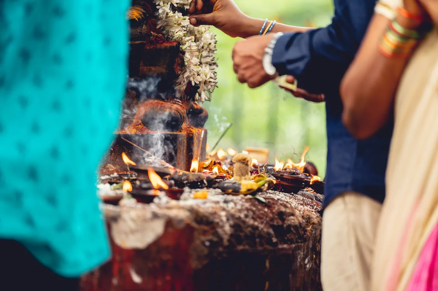 A Hindu ritual with flowers, flames and incense